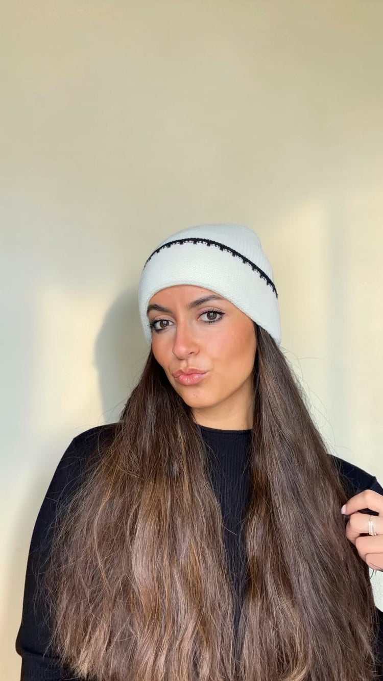Woman with long hair wearing the Ivory and Black Contrast Stitch Knit Beanie