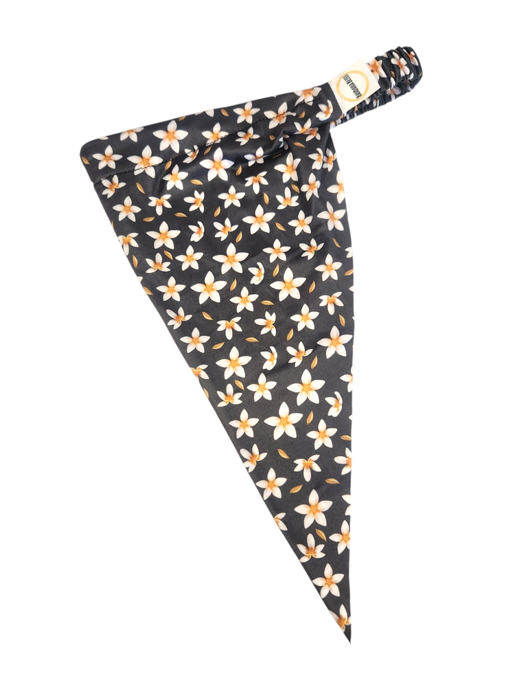 Flower Dreams pre-tied bandana angled flat view, small cream blossoms on dark charcoal